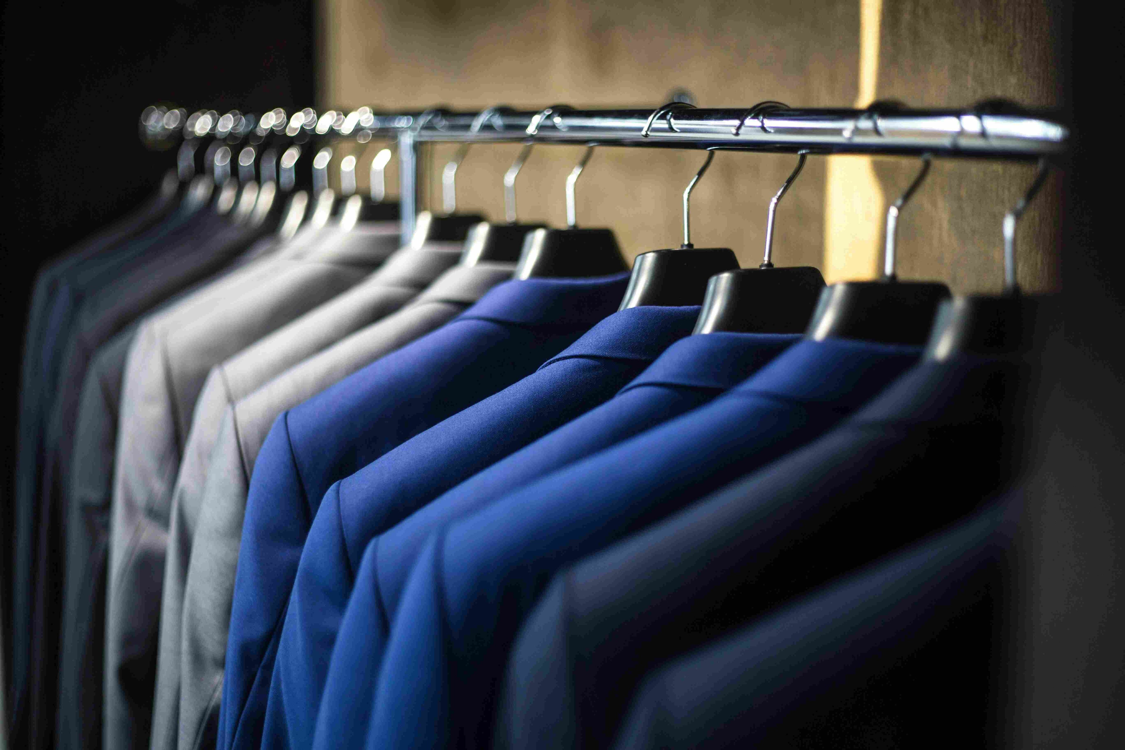 Row of suits on hangers in a store setting